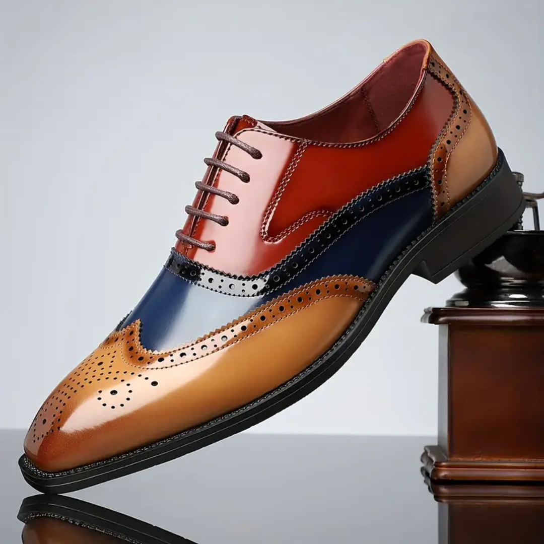 Tri-colour leather brogue shoe balanced on vintage coffee grinder