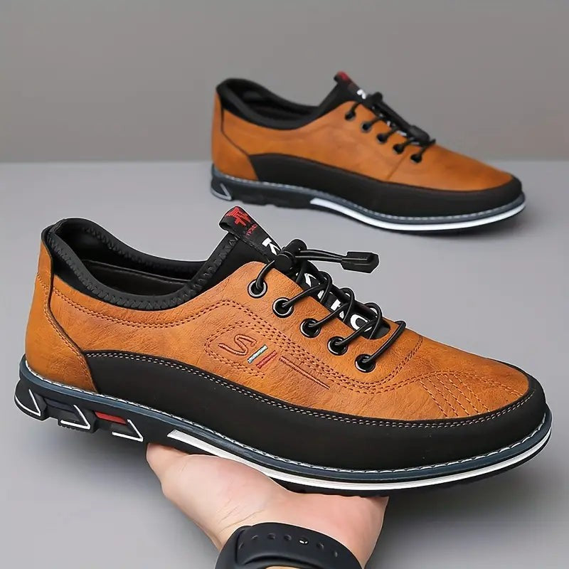 Pair of tan leather casual shoes with black soles and stitched detailing