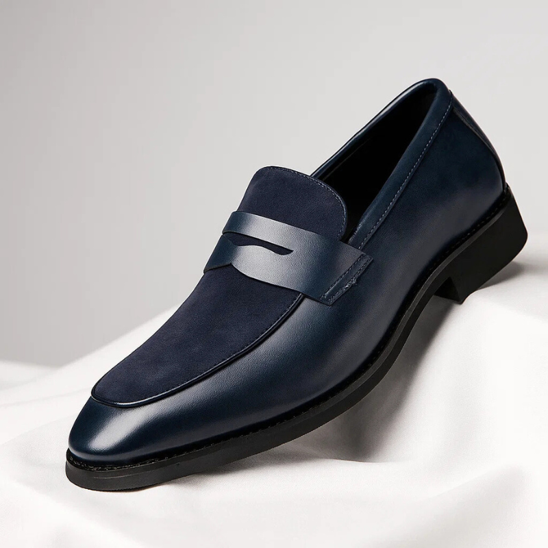 Men's navy suede penny loafer with sleek leather trim and slip-on style
