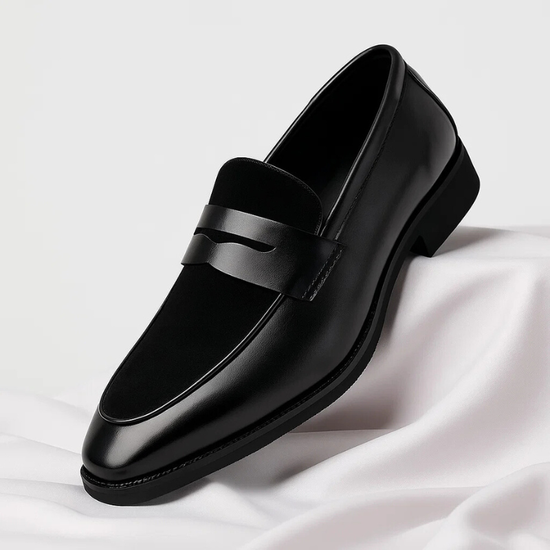Black leather penny loafer featuring suede heel panel and polished finish
