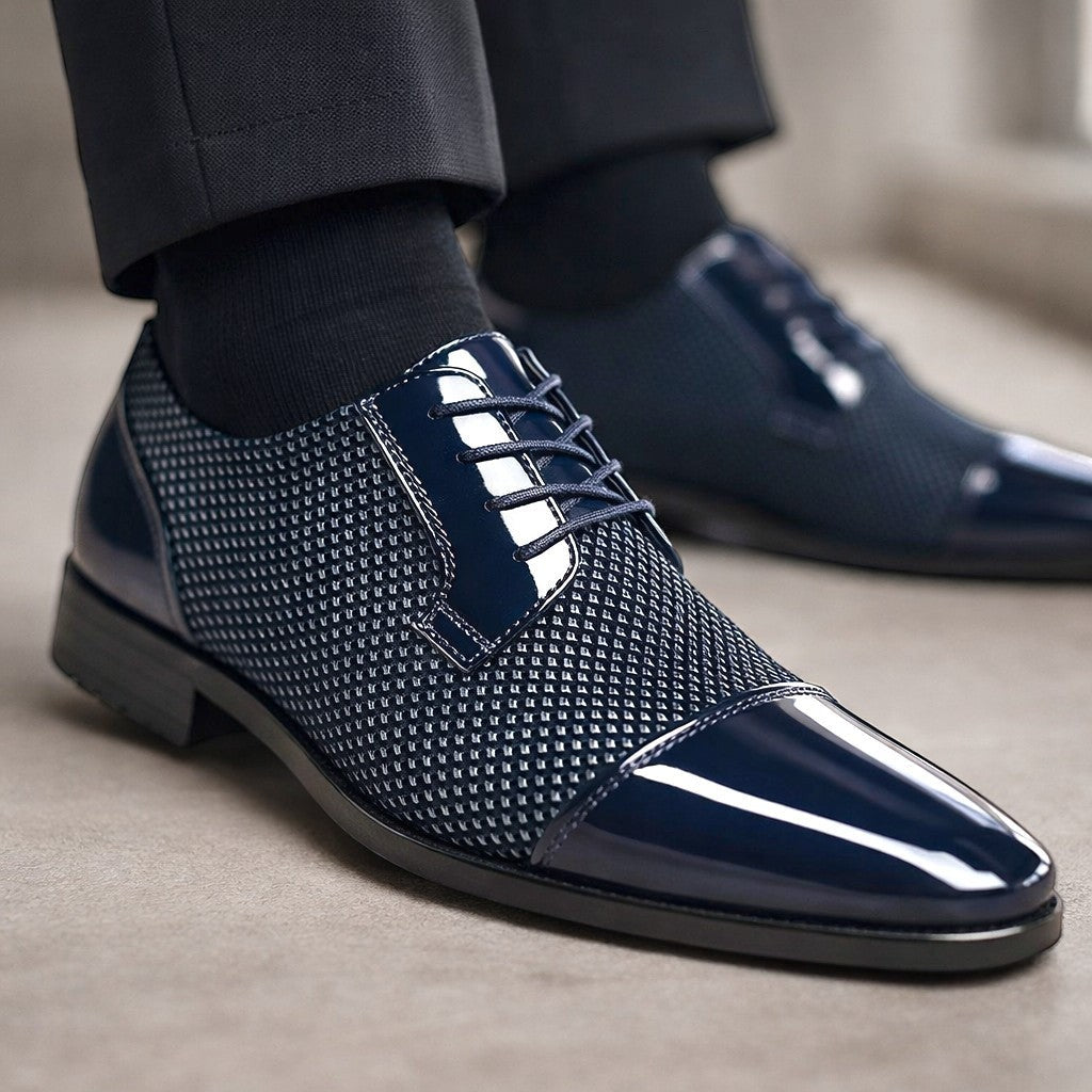 Close-up of navy patent cap-toe Oxford shoe worn with tailored suit trousers