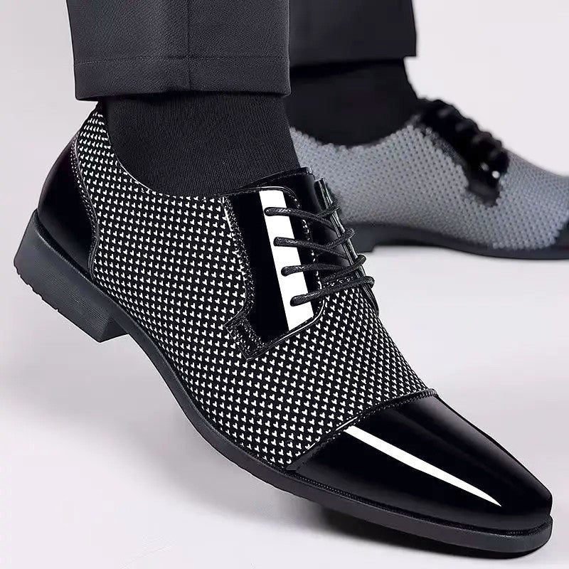 Black and white textured Oxford shoes with patent cap toe on model's feet