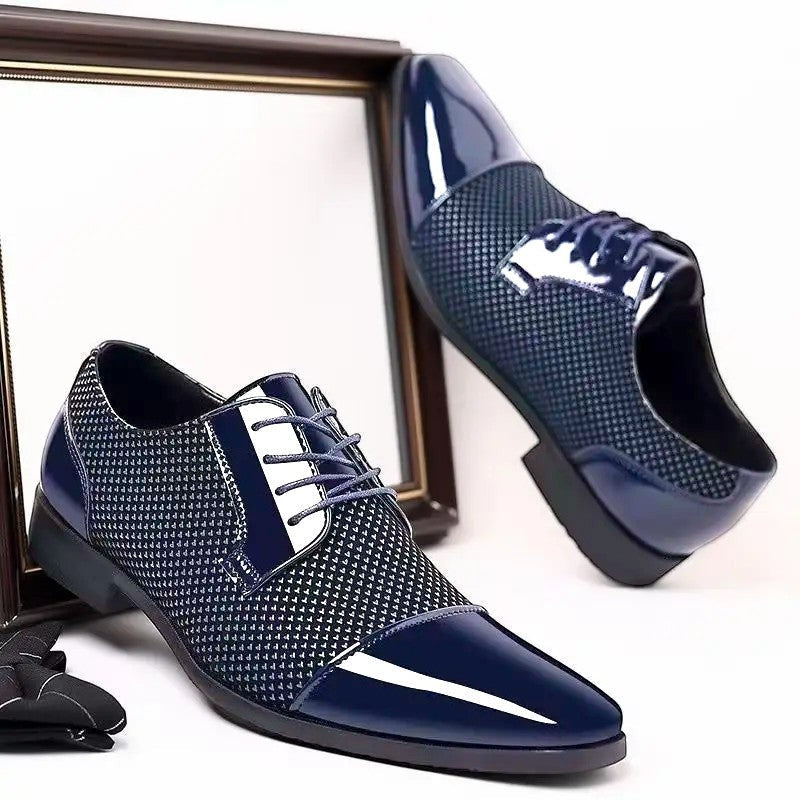 Pair of navy patent cap-toe Oxford shoes displayed beside a mirror frame