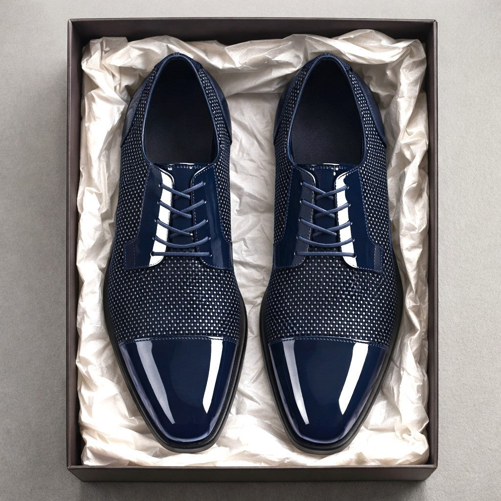 Navy patent Oxford shoes with textured panels presented in a gift box