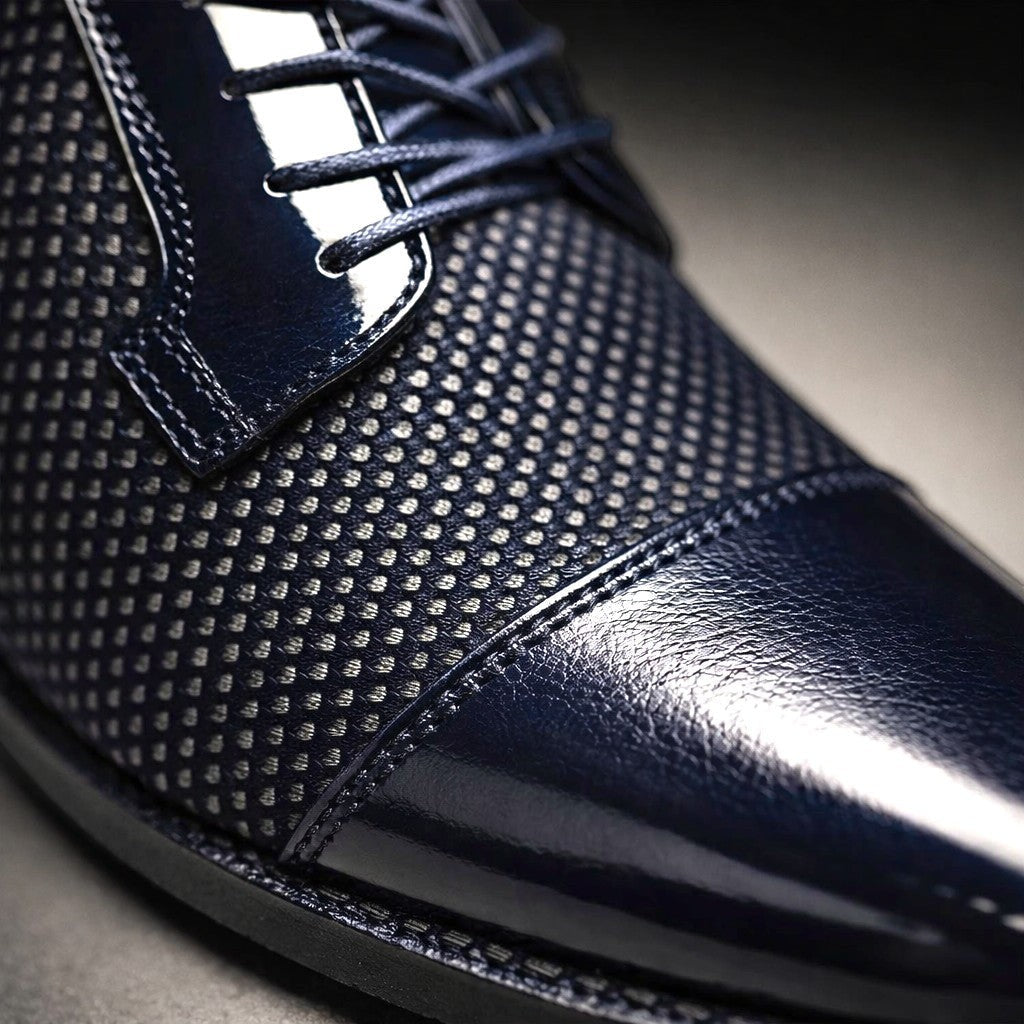 Close-up detail of navy patent cap toe and textured upper on Oxford shoe
