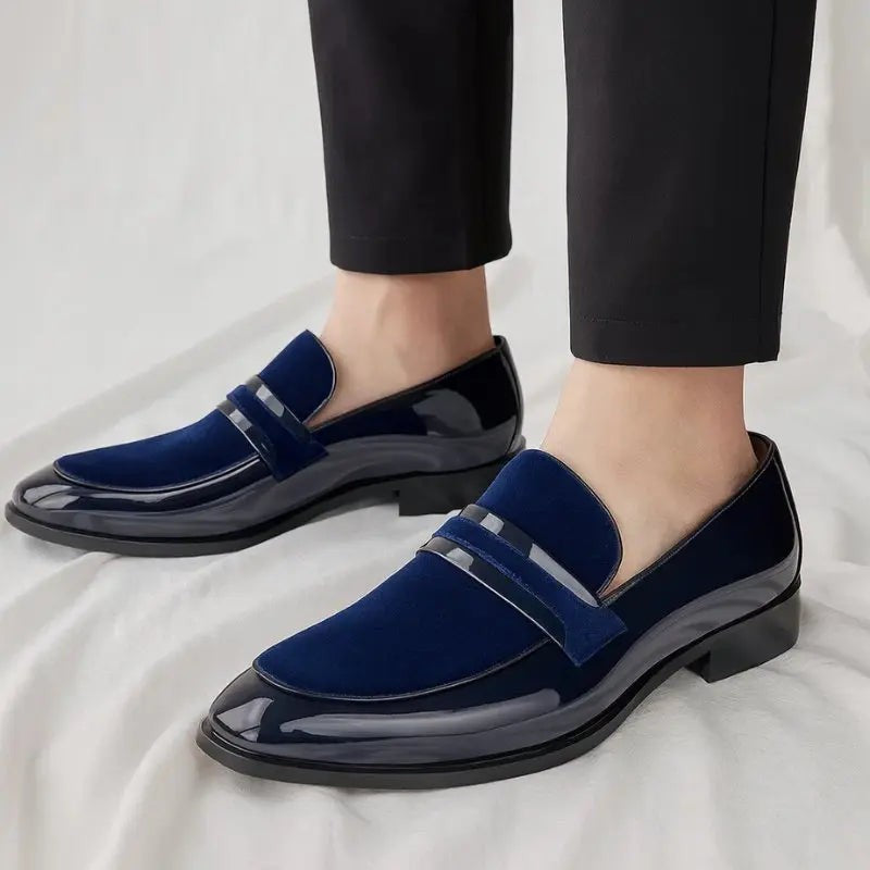 Man wearing navy patent suede loafers styled with tapered black trousers