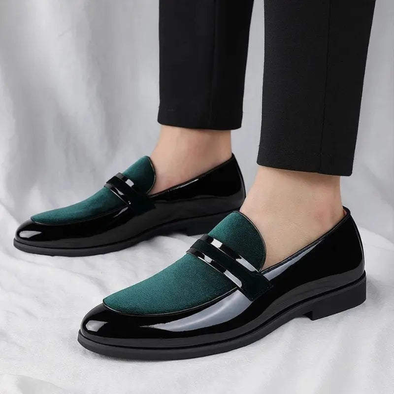 Green suede and black patent loafers worn with slim black trousers