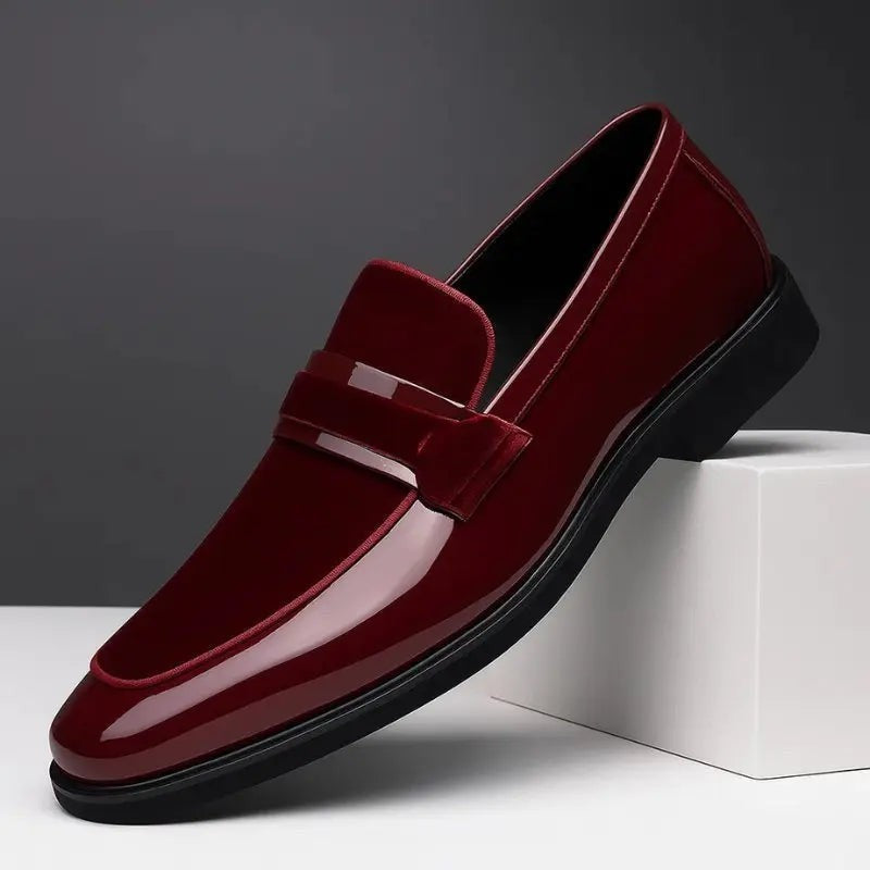 Burgundy patent leather loafer featuring suede penny strap and pointed toe