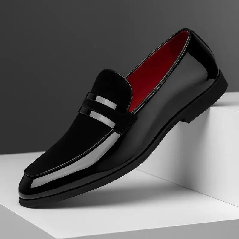 Black patent leather penny loafer with pointed toe and glossy finish