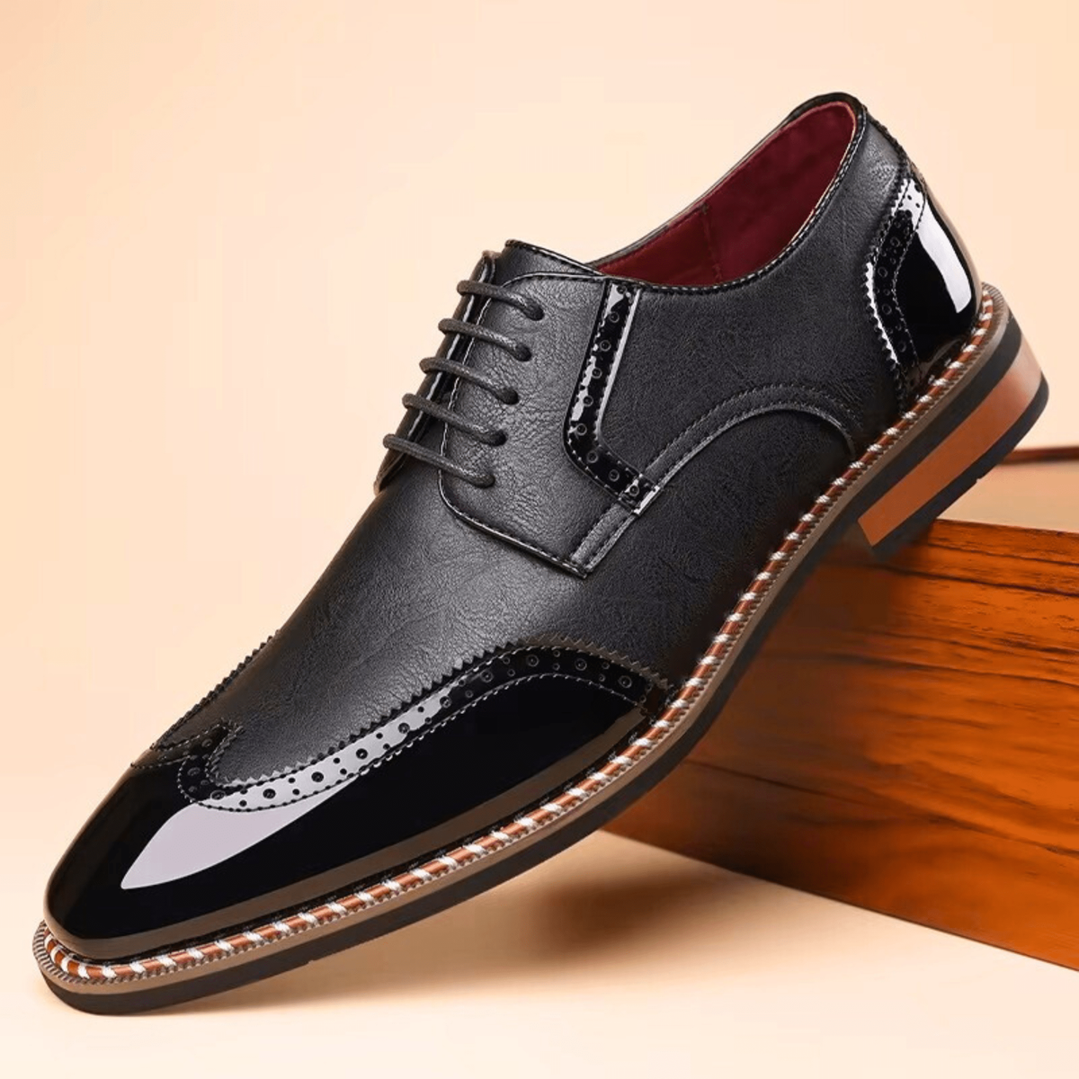 Black leather wingtip brogue Oxford shoe with patent panel detailing