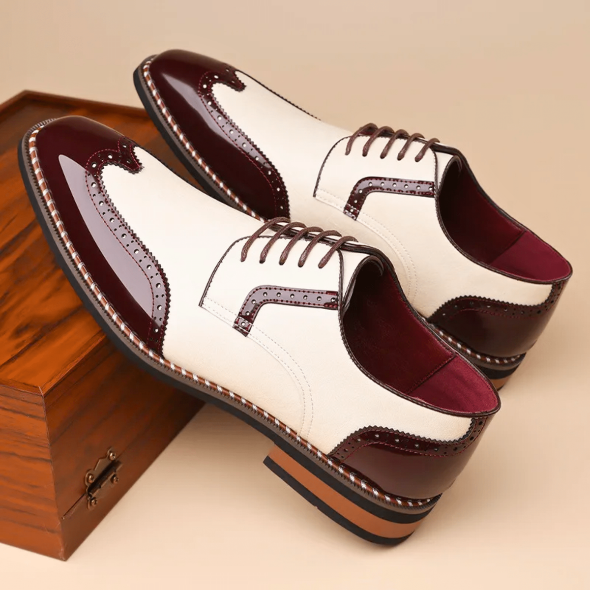 Pair of cream and burgundy two-tone wingtip brogue Oxford shoes