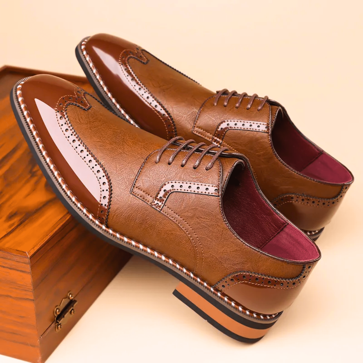 Pair of tan two-tone brogue Oxford shoes with patent leather accents