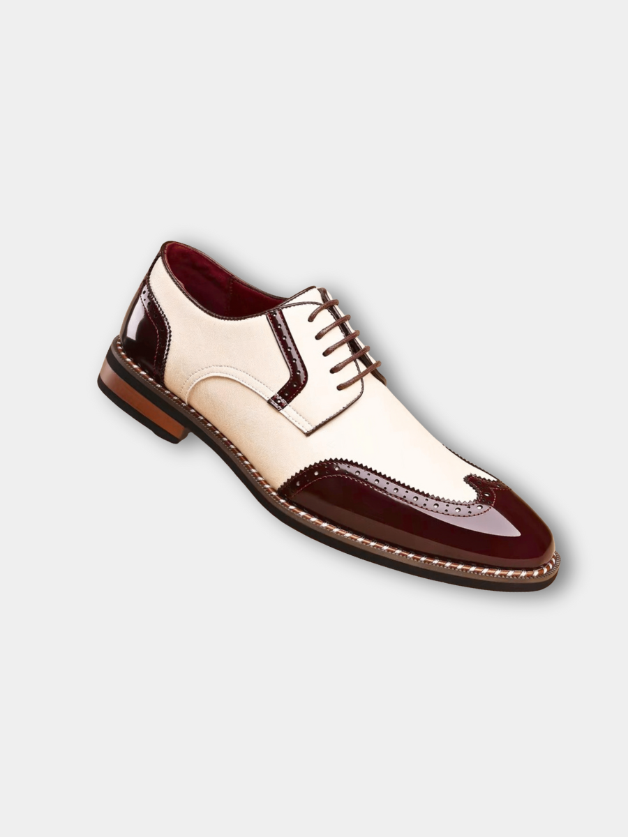 Two-tone burgundy and cream patent leather brogue shoe with wingtip detailing