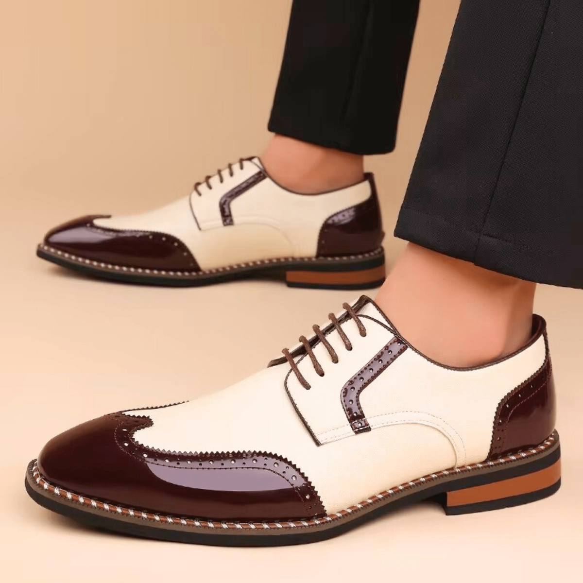 Man modelling cream and burgundy two-tone brogue derby shoes