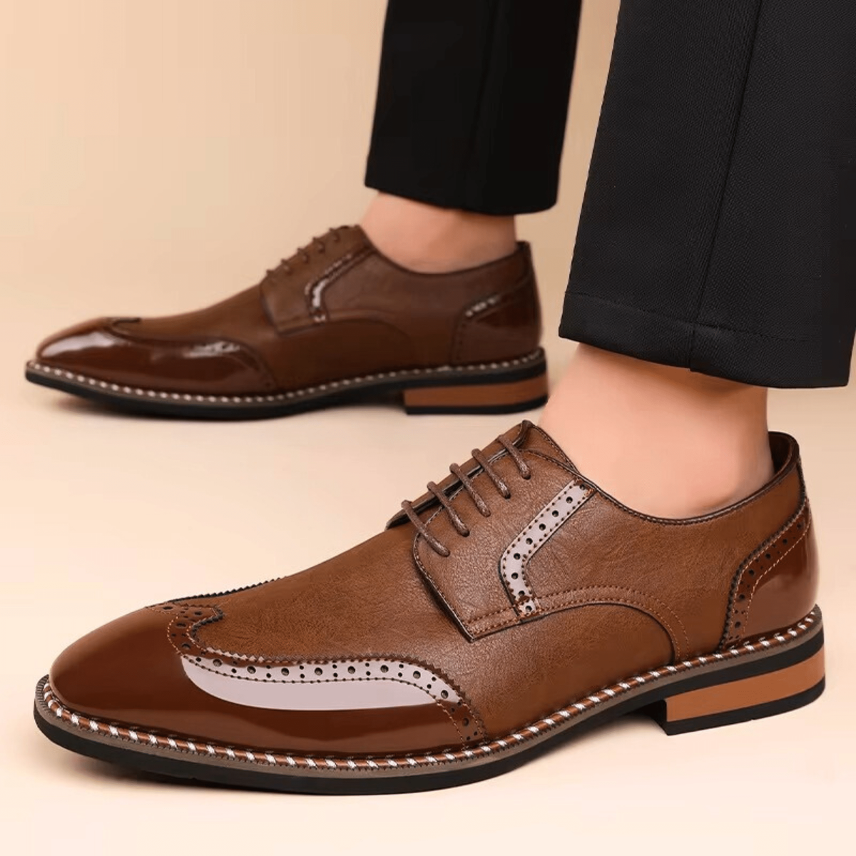 Man modelling tan and brown wingtip brogue shoes with patent finish