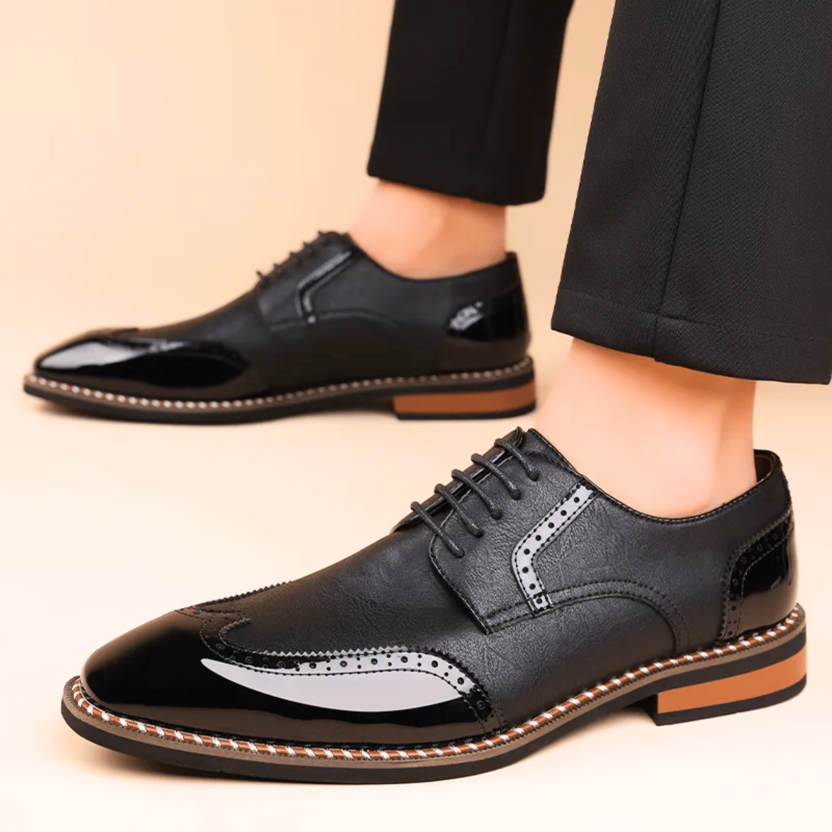Man modelling black patent leather brogue shoes with lace-up front