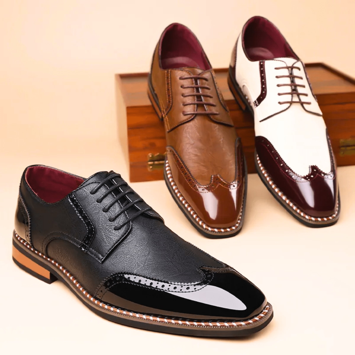 Three bicoloured brogue shoes shown in black, tan and white burgundy trim