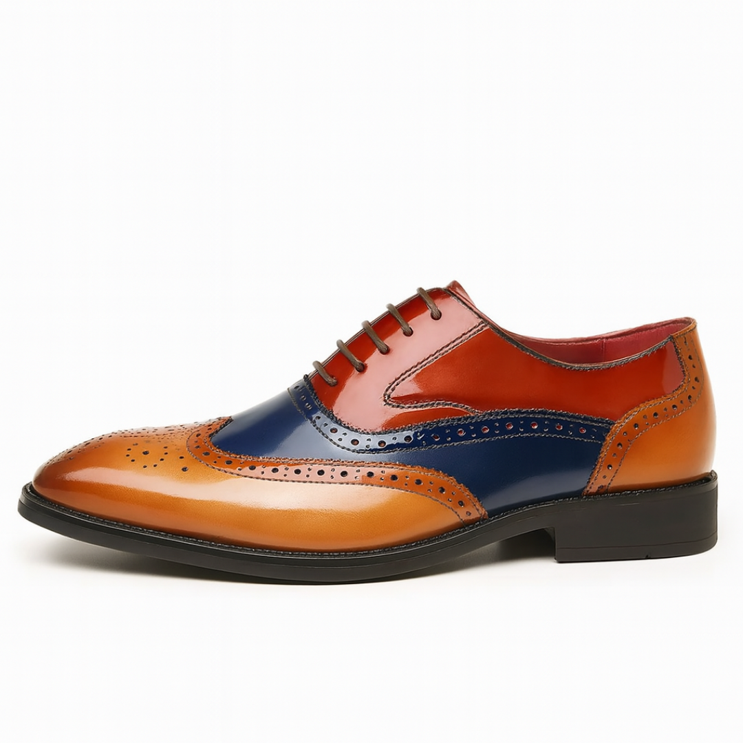 Side profile of tan, navy and red leather wingtip brogue shoe