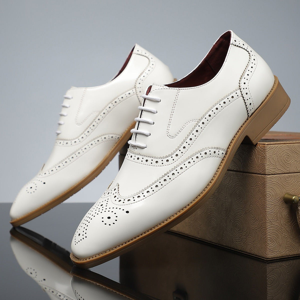 Cream leather wingtip brogues with tan sole and lace fastening
