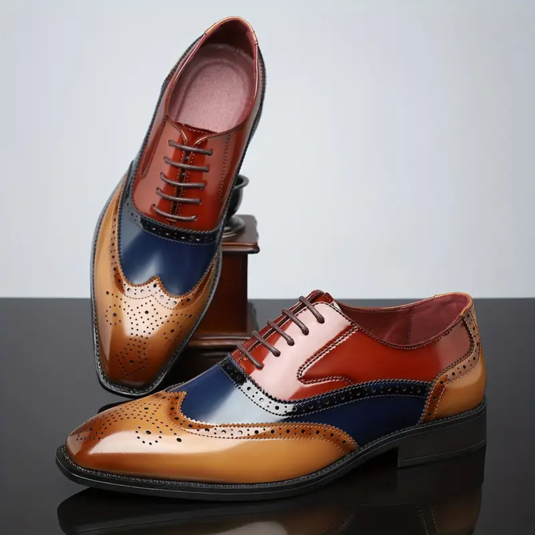 Colour-block leather wingtip brogues showing red suede-lined interior
