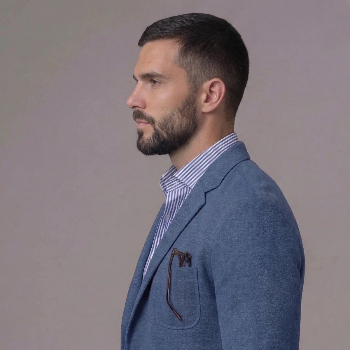 Rear view of tailored blue blazer showing fitted back panel