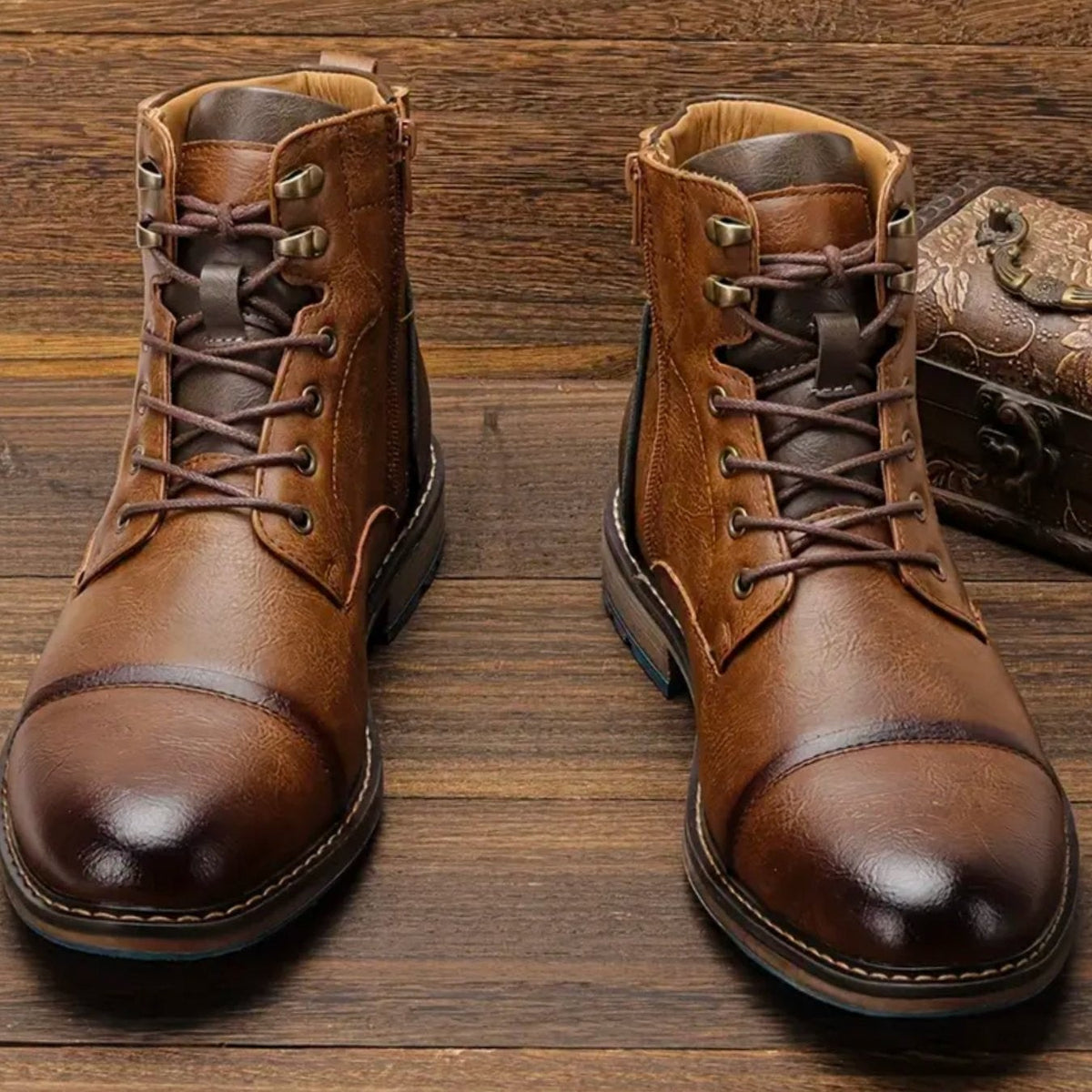 Pair of vintage-style leather ankle boots with bronze eyelets and stitched detailing