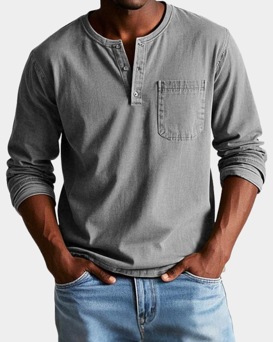 Grey long-sleeve henley top featuring button placket and pocket detail
