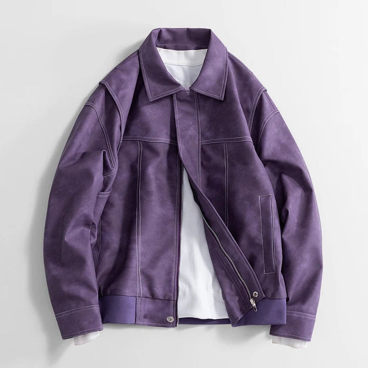 Purple faux leather bomber jacket with contrast stitching, laid flat