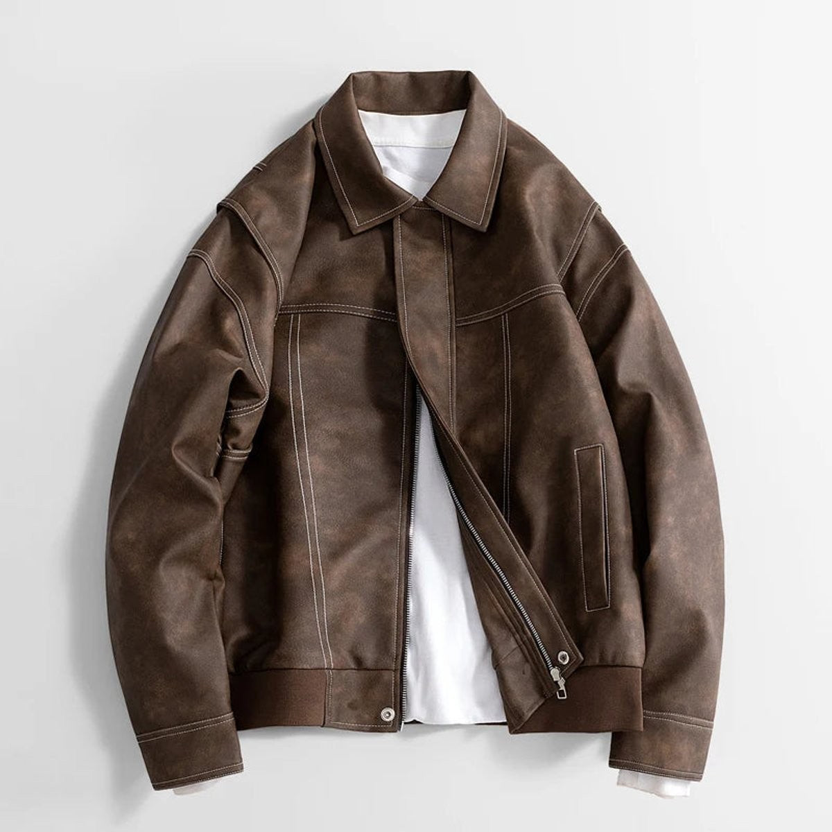 Close-up of brown faux leather jacket showing zip and collar detail