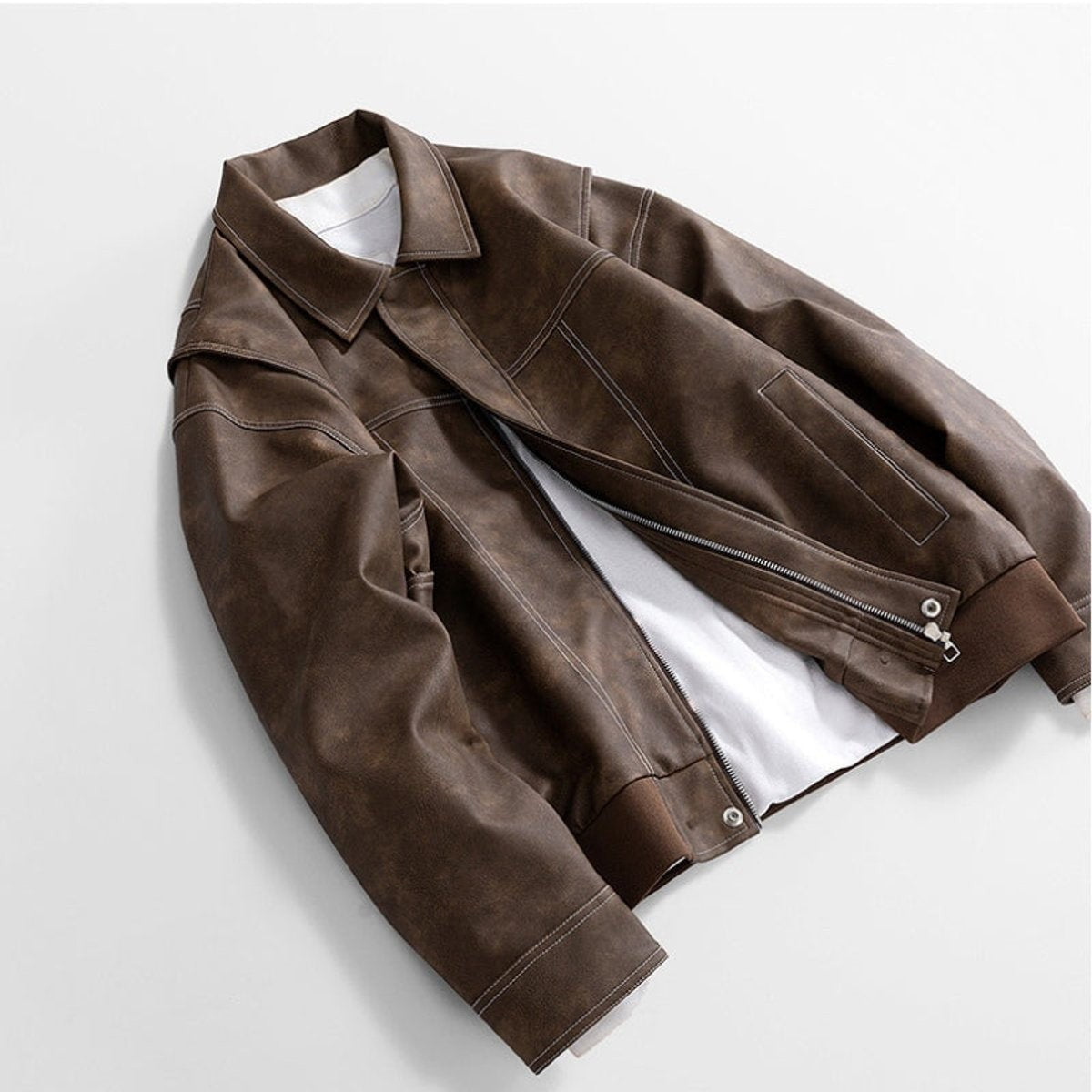 Brown vintage-style leather jacket draped with sleeve folded across