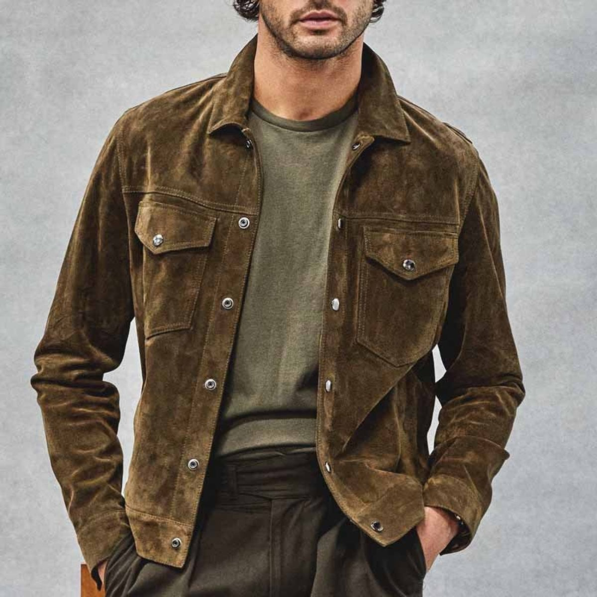 Close-up of olive suede jacket showing snap-button chest pockets