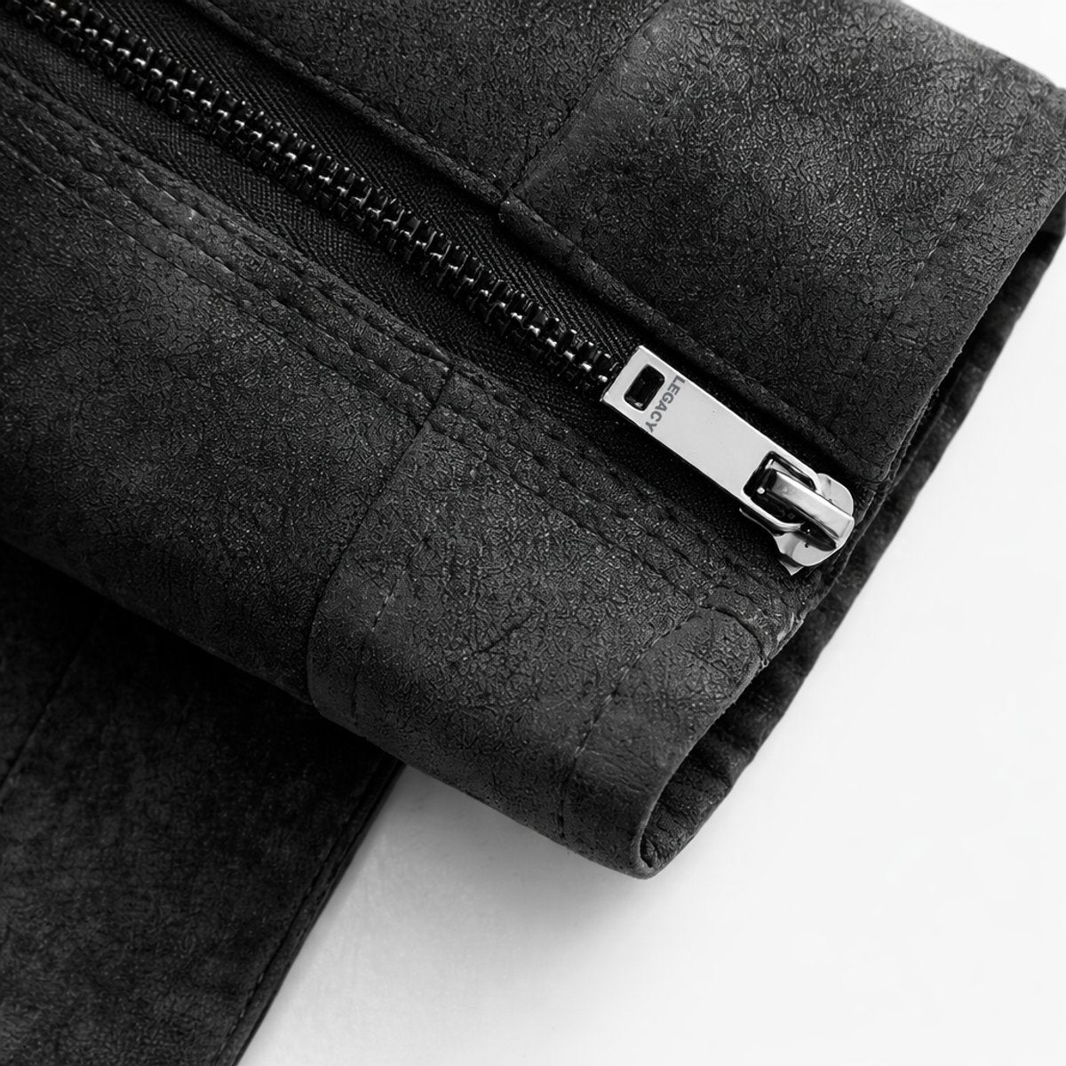 Close-up of zip pull detail on black suede-effect bomber jacket cuff