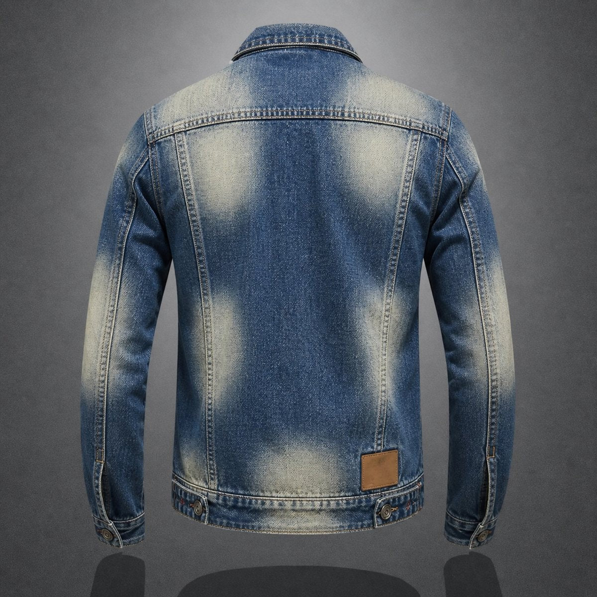 Faded blue denim jacket rear view, showing worn detailing and leather back patch