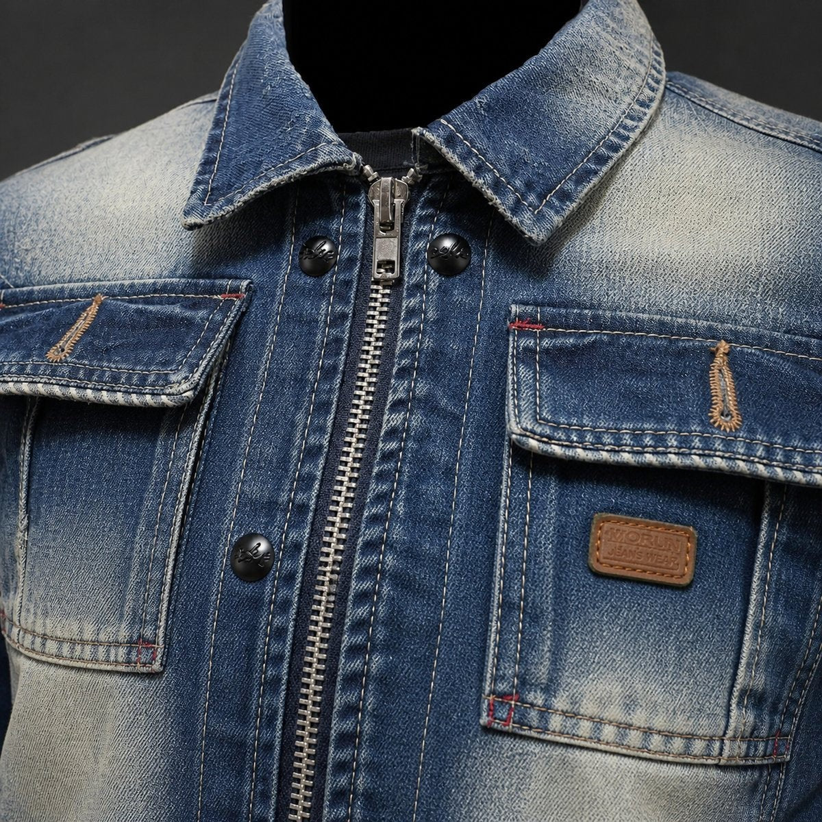 Close-up of denim jacket collar, zip fastening and stitched flap pockets