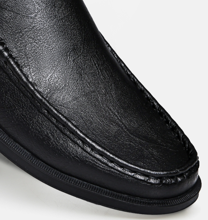 Close-up of black leather loafer toe with stitched seam
