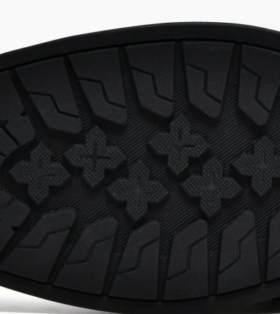 Textured rubber sole close-up on black men's loafer