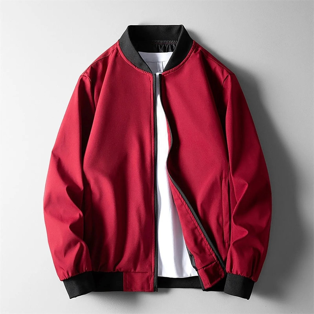 Red softshell bomber jacket with contrasting black ribbed trim and collar