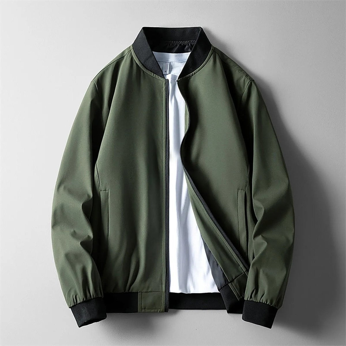 Khaki green softshell bomber jacket with black ribbed hem and cuffs