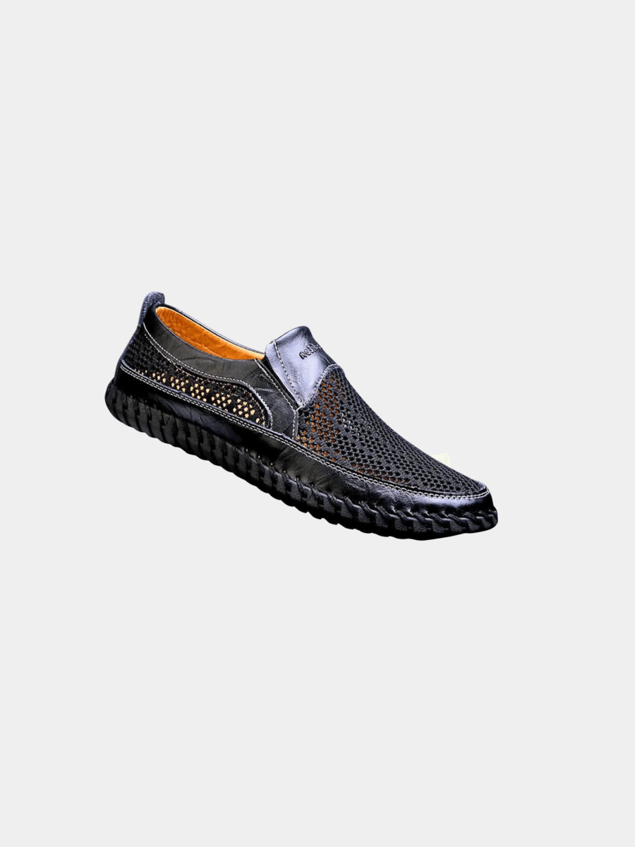 Black leather slip-on shoe with perforated mesh panels and stitched sole