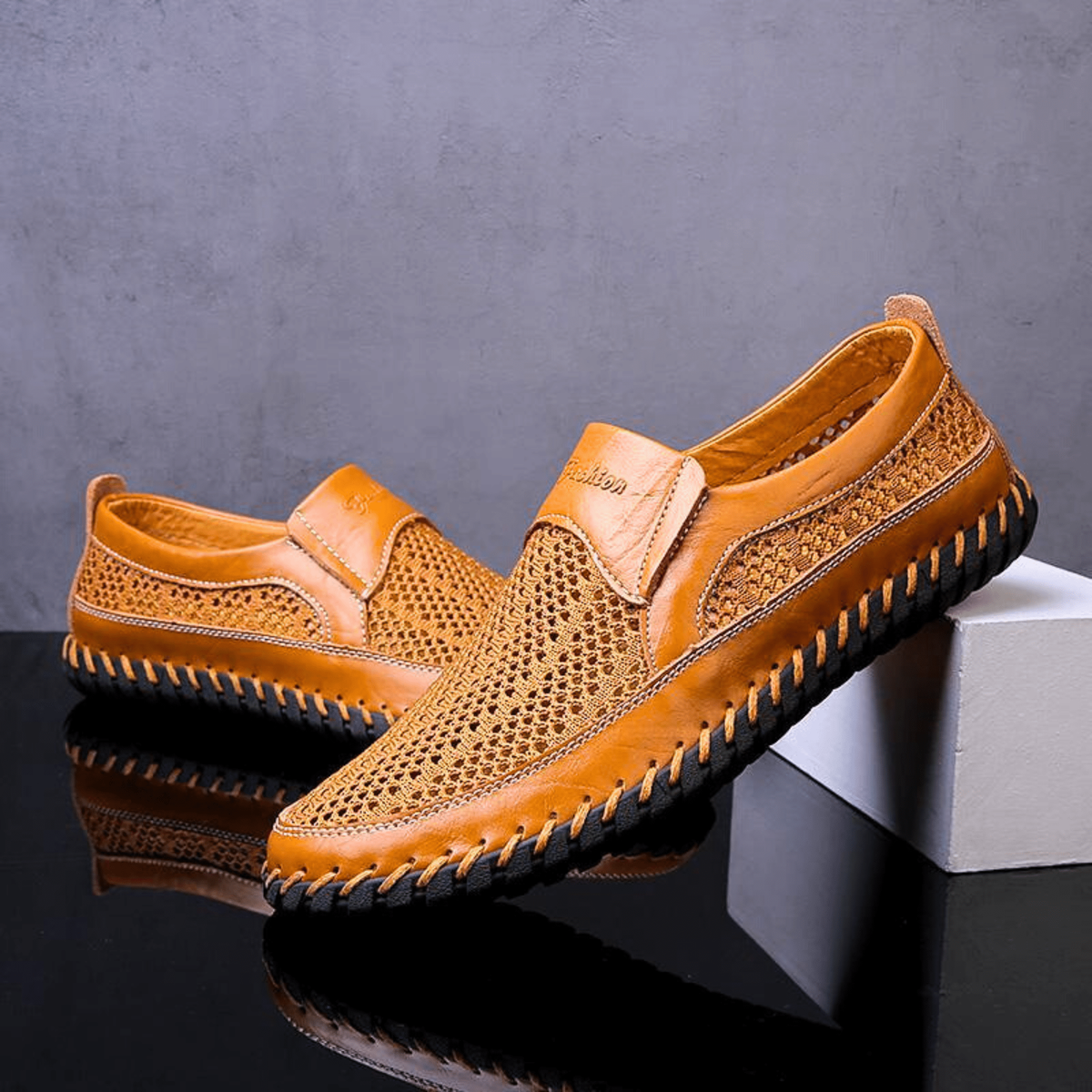 Pair of mustard leather loafers with mesh panelling and whipstitched soles