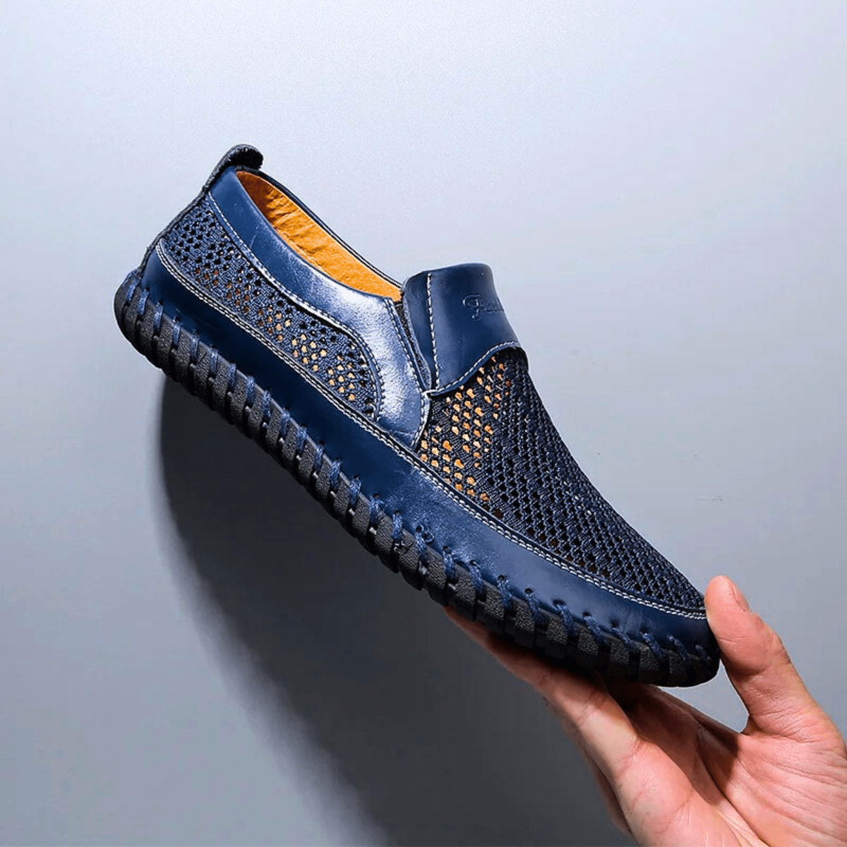 Navy leather loafer with breathable mesh panelling and contrast stitched sole