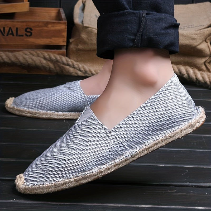 Model wearing grey canvas espadrille with jute trim, side angle